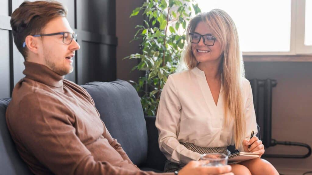 Therapist supporting a patient during PTSD treatment in Orange County