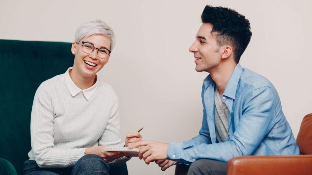 Two people in a counseling session discussing bipolar disorder treatment in Orange County