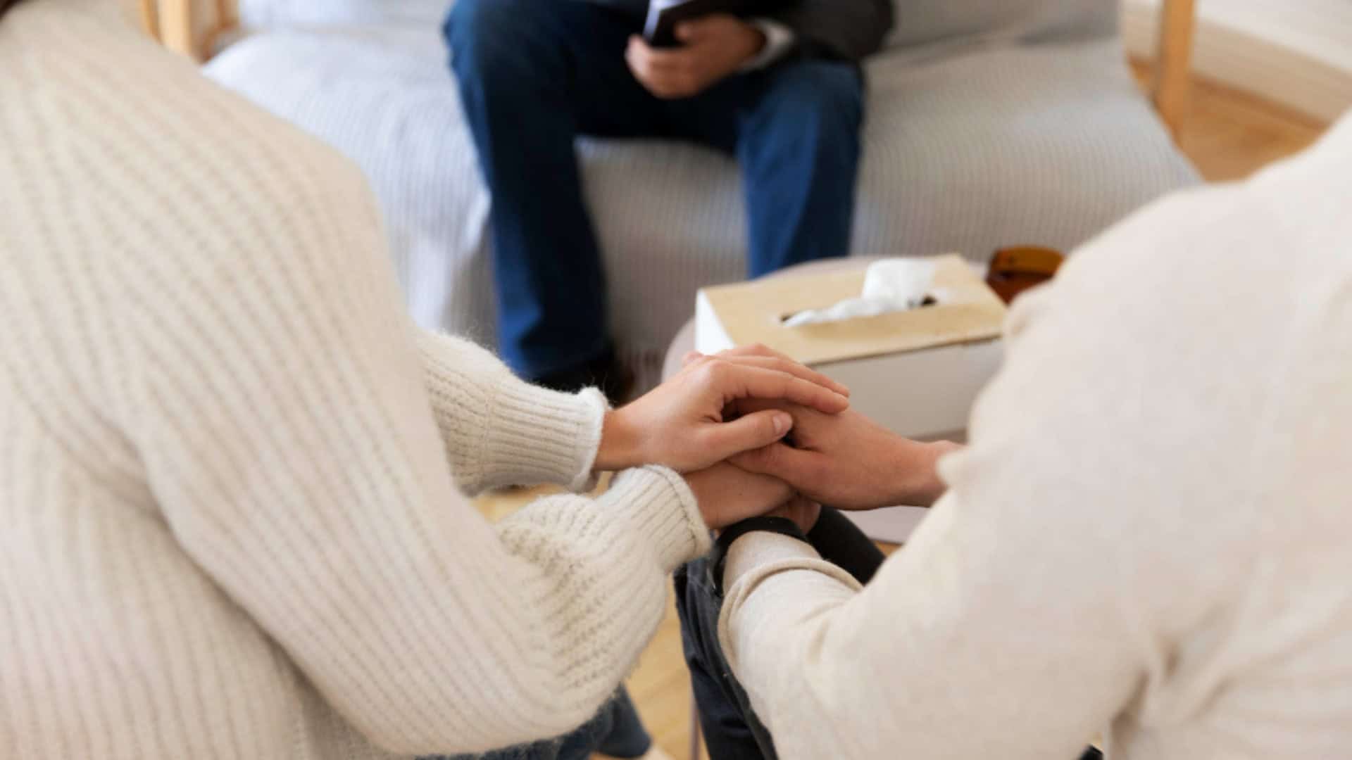 Couple holding hands during anxiety treatment in Orange County, showing emotional connection in a counseling session